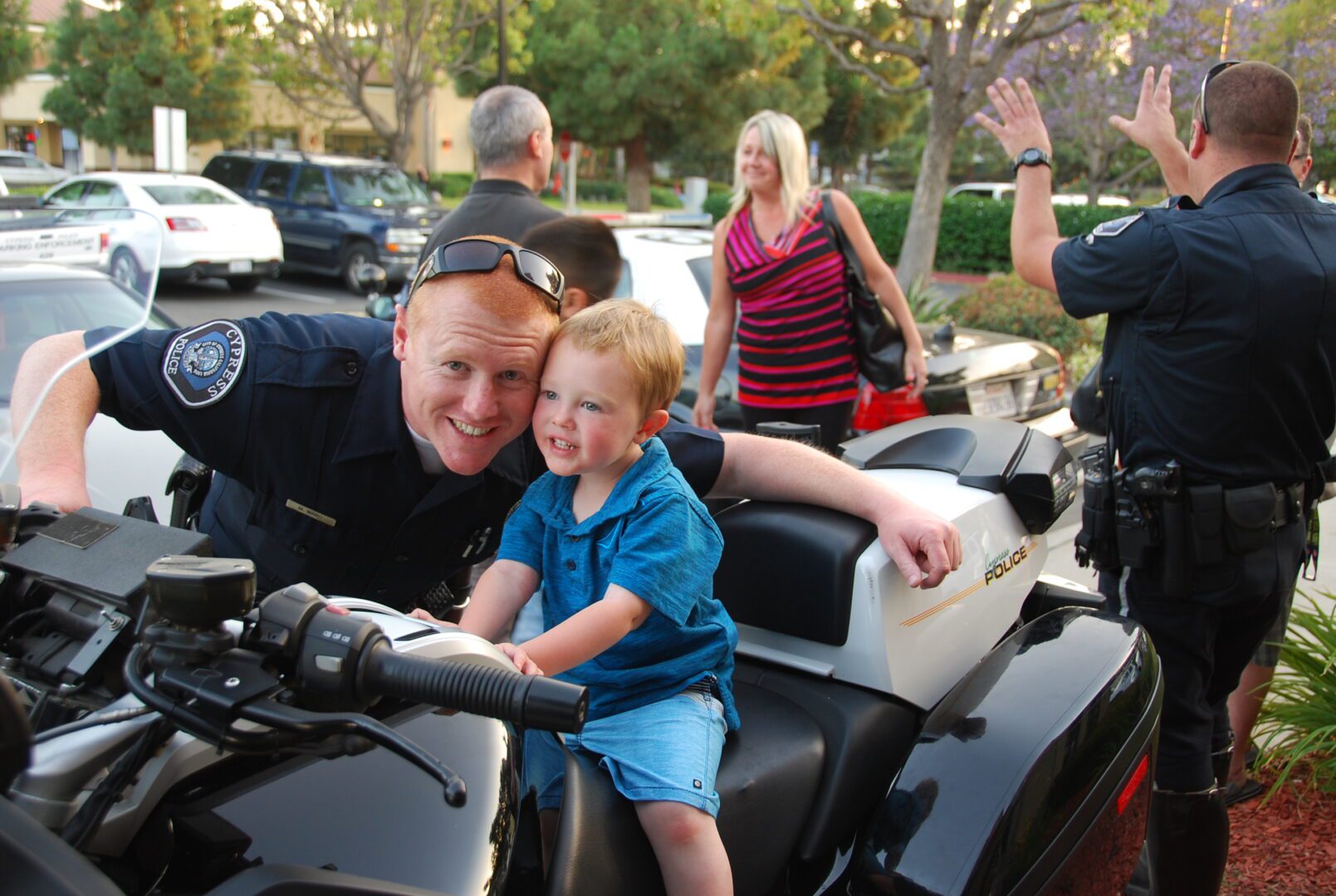 A police officer and his son on a motorcycle.