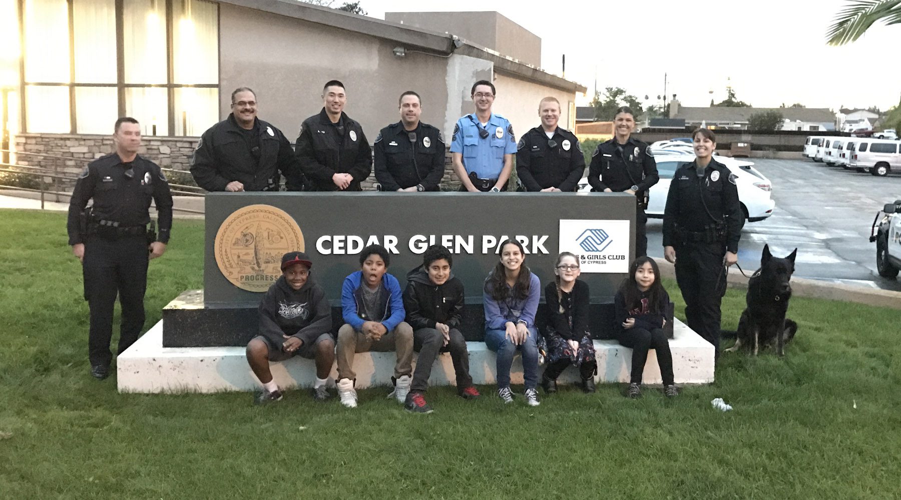 A group of people posing for a picture in front of a sign.