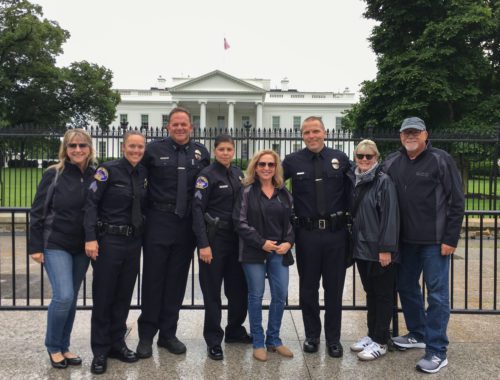 A group of people standing in front of the white house.