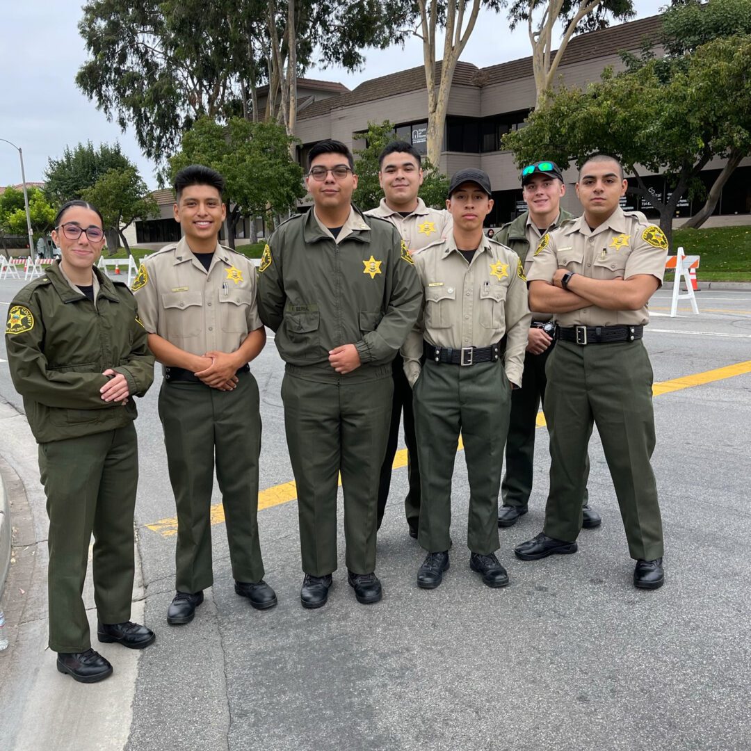 A group of people in uniform standing on the side walk